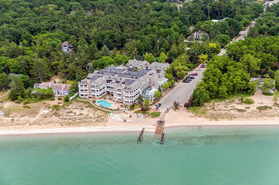 Overhead view by drone of LeBear Resort, the town boat launch, and Blu Fine Dining restaurant on the waterfront at Lake Street in Glen Arbor