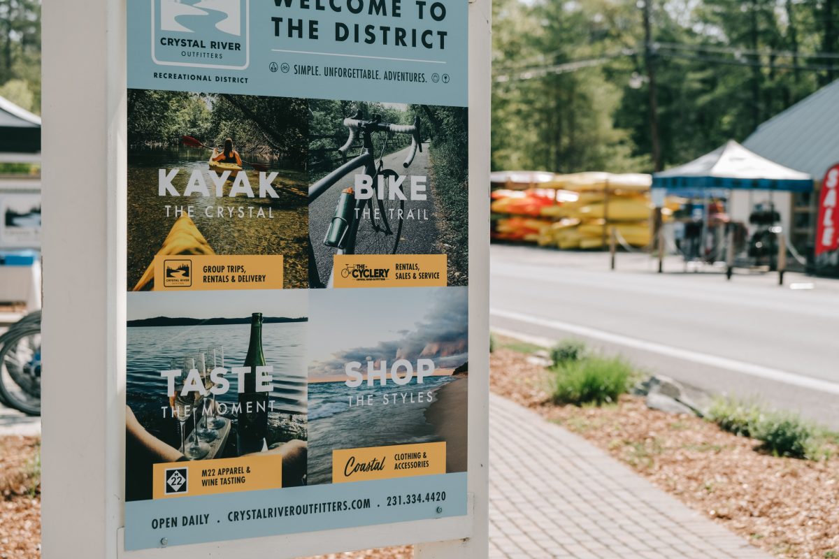 Outdoor sign at the sidewalk on Western Avenue for the Crystal River Outfitters Recreation District