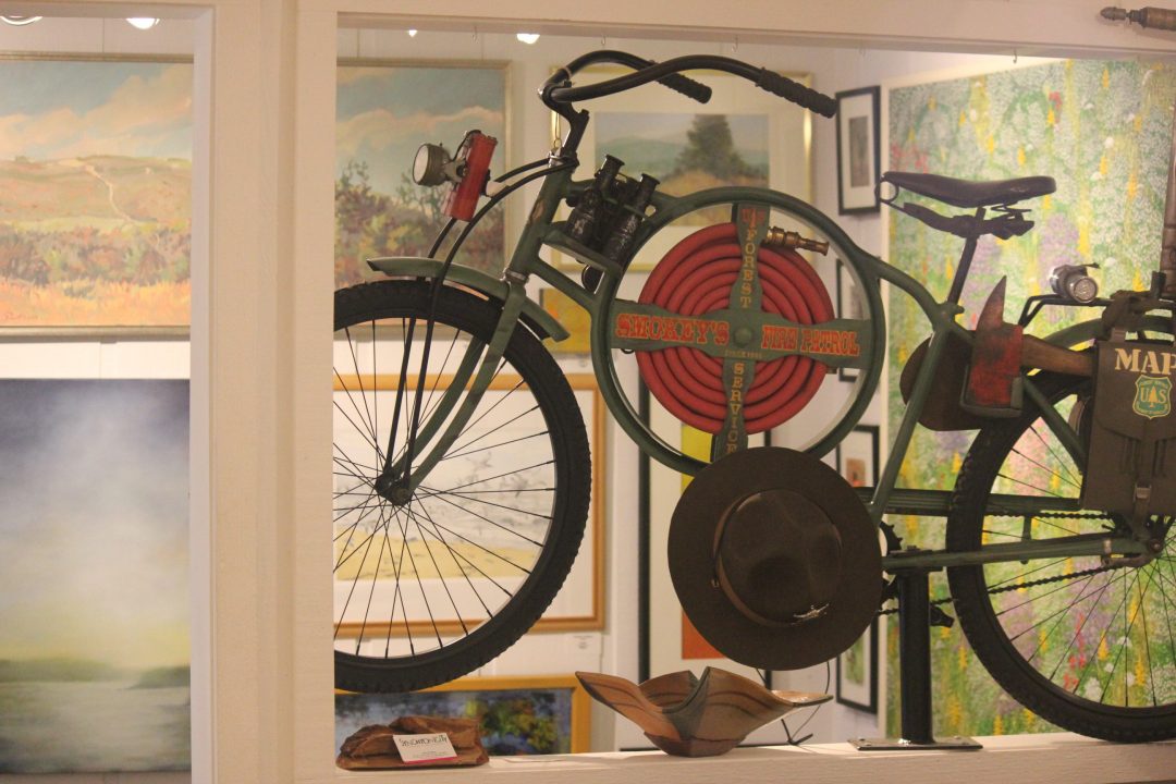 antique refinished bike on display in gallery