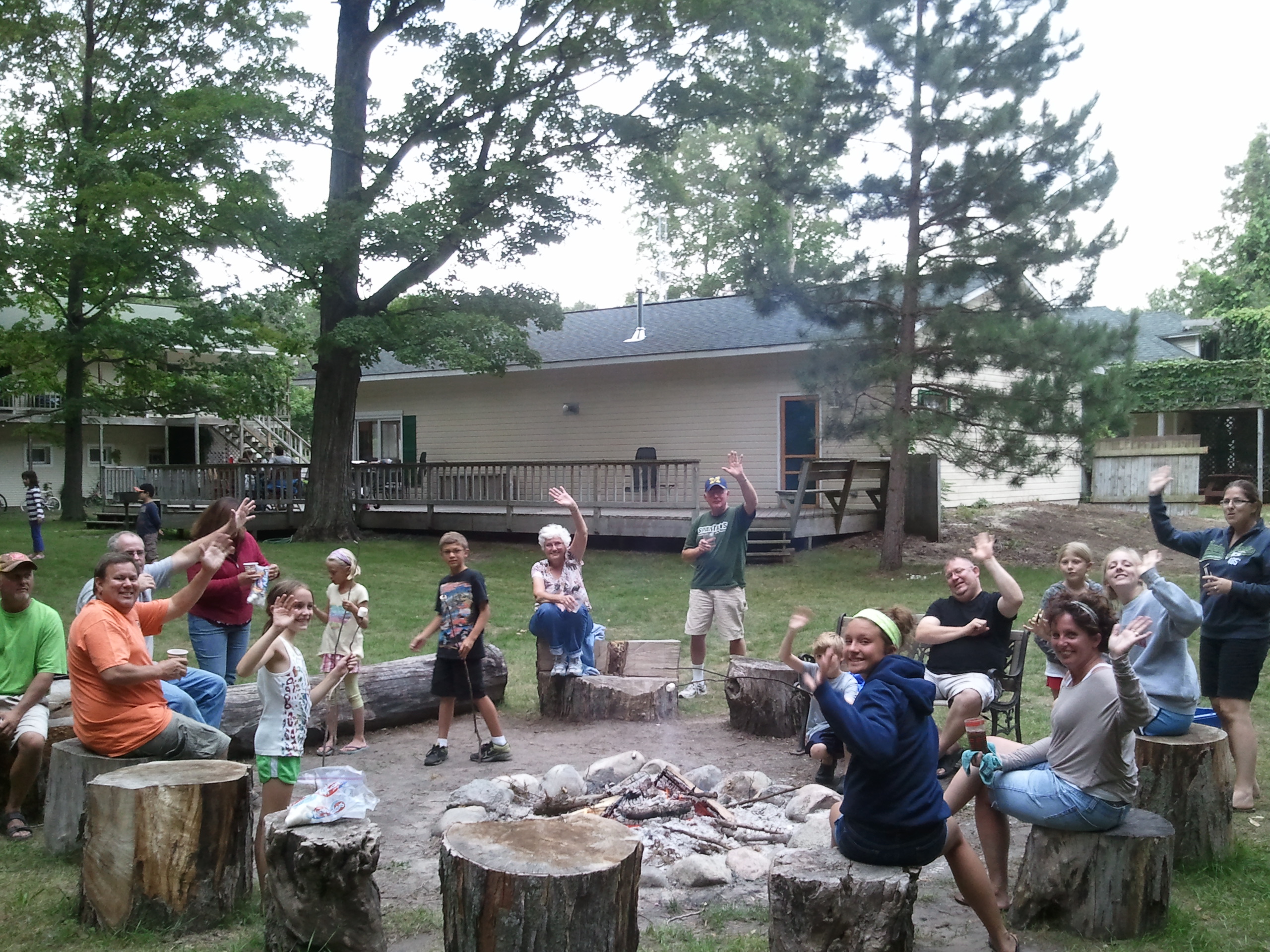 family enjoying outdoor space and bonfire at maple lane resort