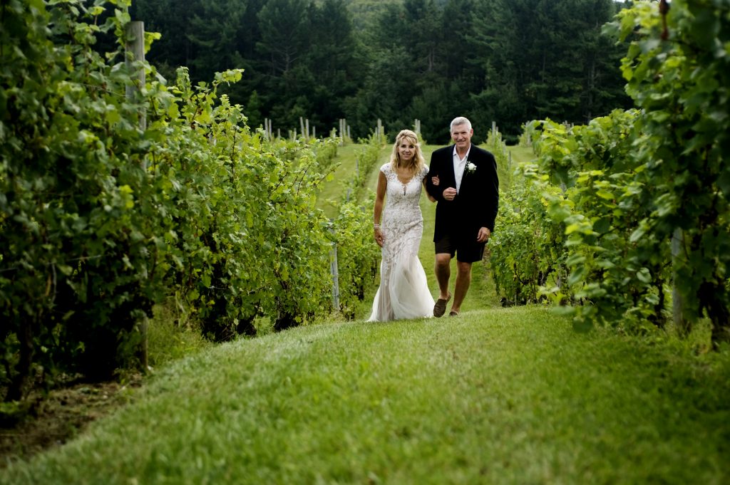 wedding couple walking in vineyard on the Leelanau Peninsula in Michigan