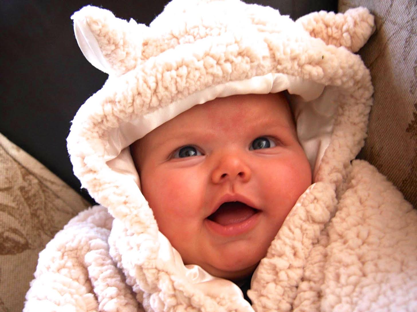 baby wrapped in cuddly lamb blanket