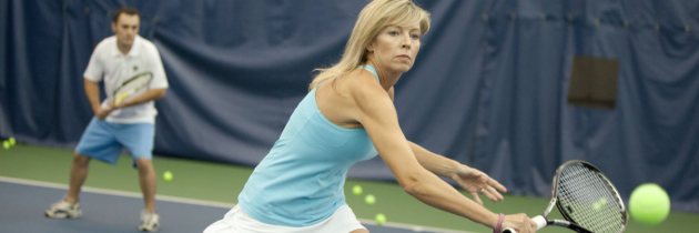 woman action shot playing tennis