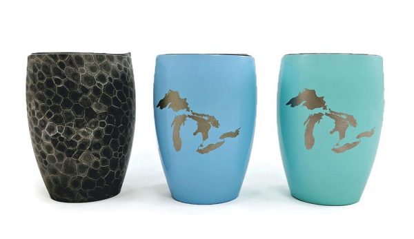 Multi-colored tumblers superimposed with a map of Michigan which may be purchased at Momentum of Glen Arbor