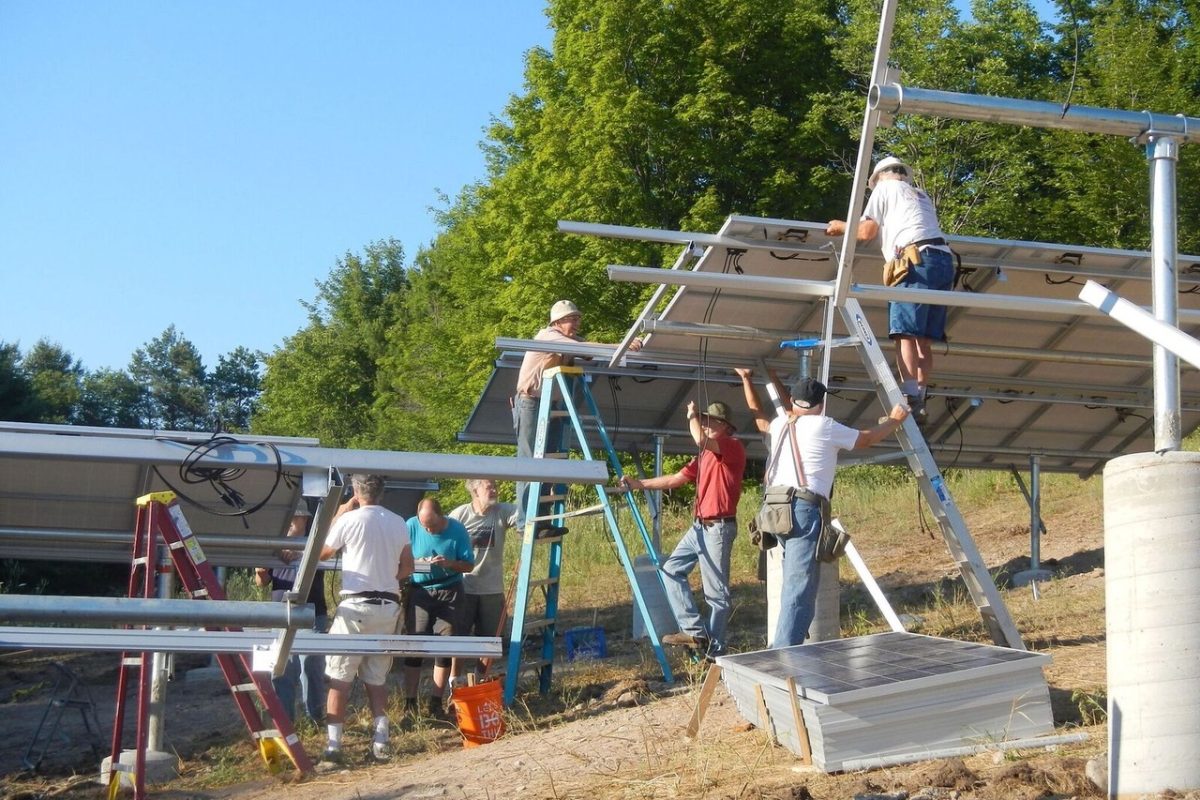 workers installing solar panels for leelanau energy