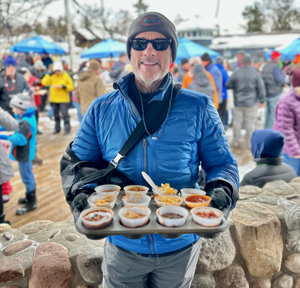 holding chili samples at the 2023 glen lake winterfest, chili cook-off