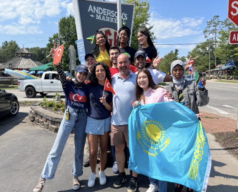 seasonal help, summer workers pose with owner Brad in front of Anderson's market in Glen Arbor MI